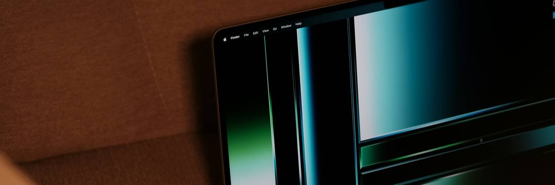 A developer's laptop displaying anonymized data fields, blurred spreadsheets, and code editor. Suitable for illustrating secure test data workflows