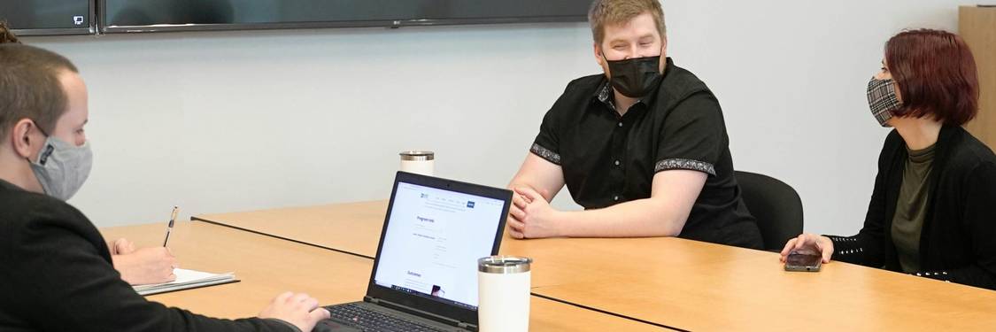 A diverse DevOps team collaborating on privacy compliance in a modern office environment