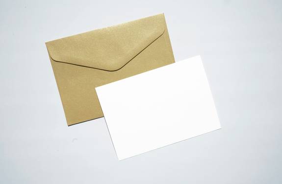 Placeholder: stock photo of a stack of envelopes on a desk, for use in a fake address generator page